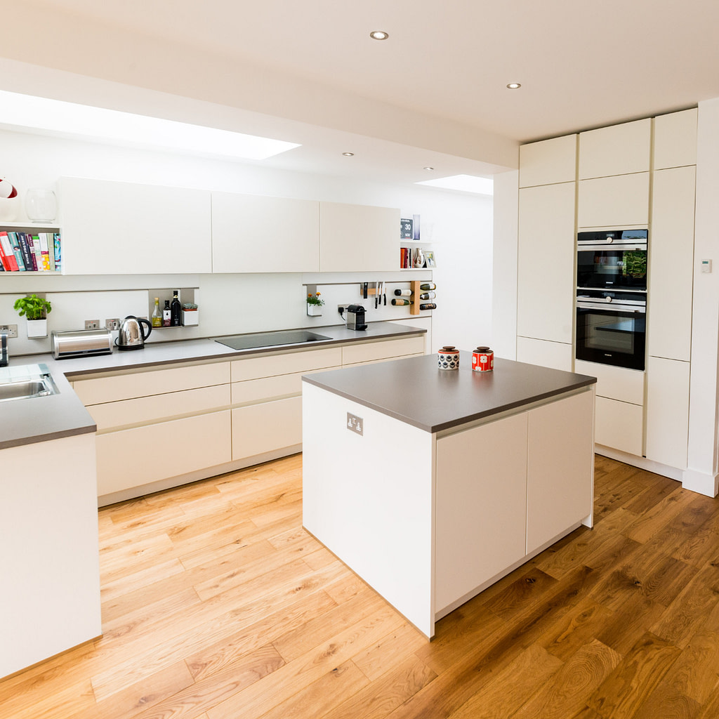 White handleless kitchen with tall cupboards